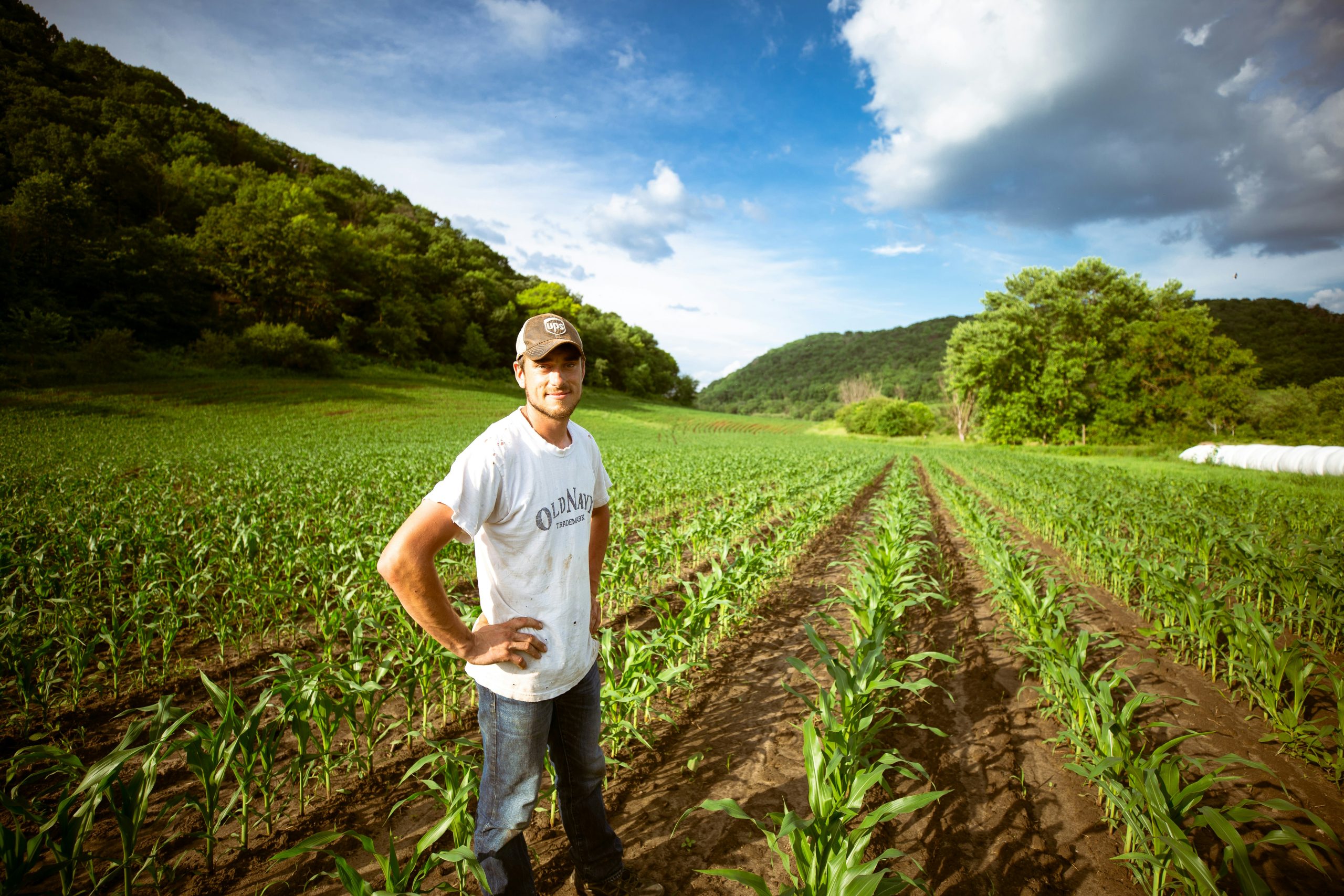 man standing in farm field during the day